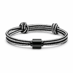 Tadblu EVER NOBLE herenarmband met zwart-wit gestreept koord, zwarte cilindervormige ashouder en verstelbare knoopsluiting.